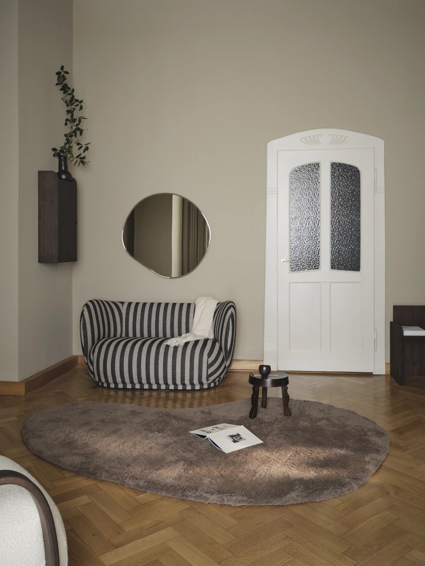 Ferm Living Rico 2-Seater Sofa in Louisiana Stripe in a warm living space with wooden floor and beige wall
