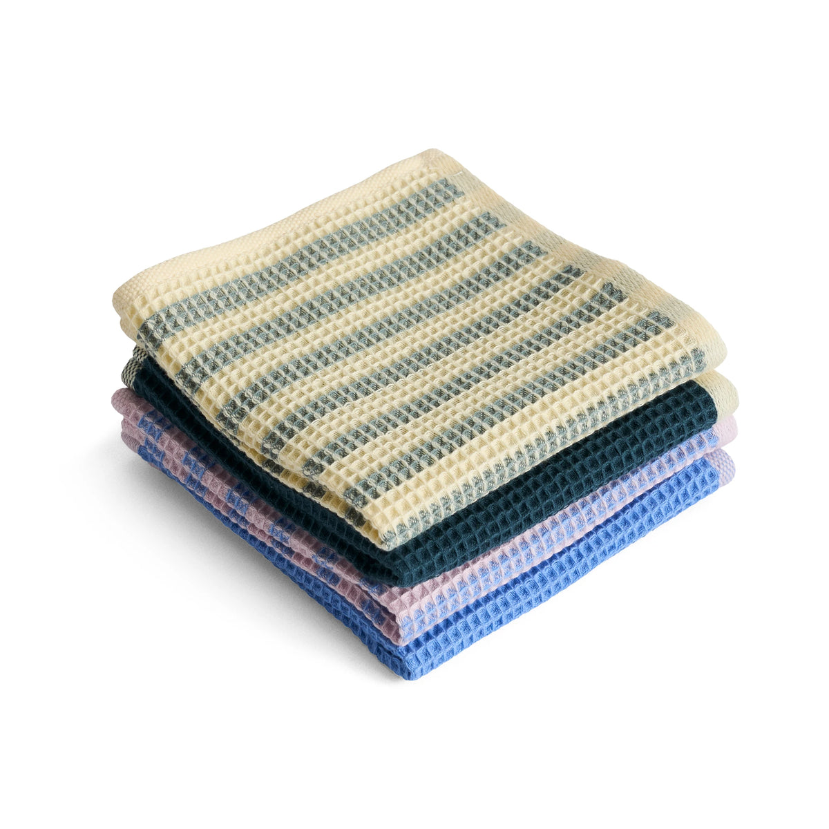 A stack of four folded waffle-weave HAY Canteen cleaning cloths on a white background. The top cloth is cream with dark green stripes, and the stack below shows dark green, black, light purple, and blue cloths.