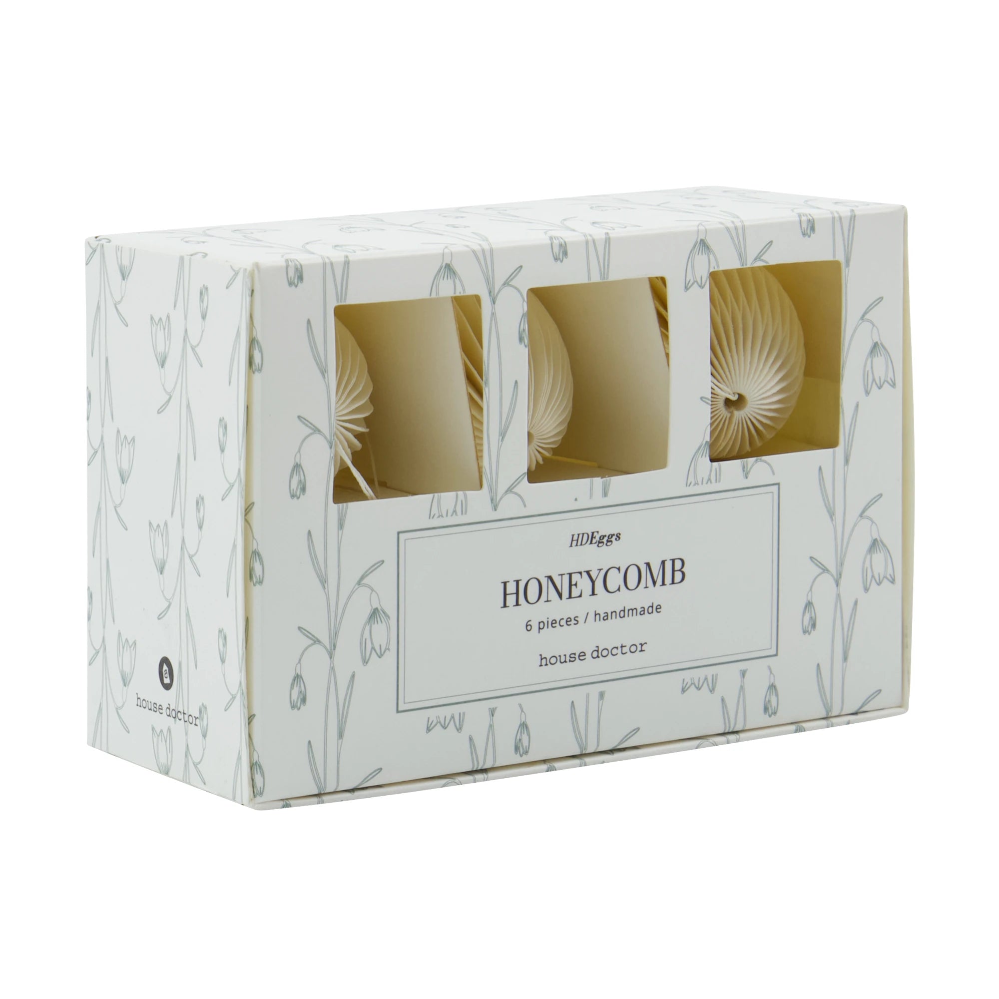 Box of honeycomb paper egg decorations with 'house doctor' branding on a white background