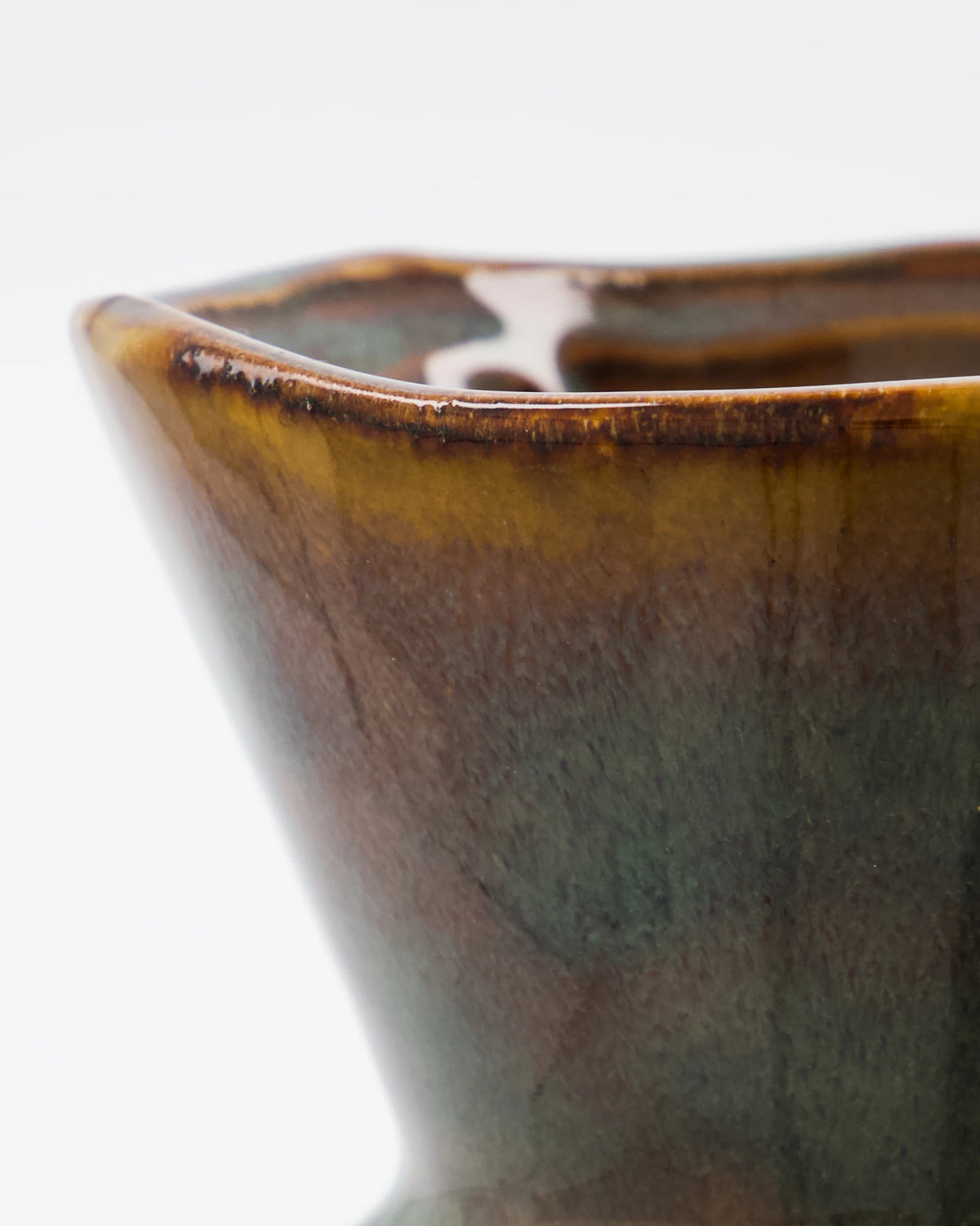 Close-up of a House Doctor HDCorp Vase in Sea Green with a glossy brown and olive-green glaze on a white background.
