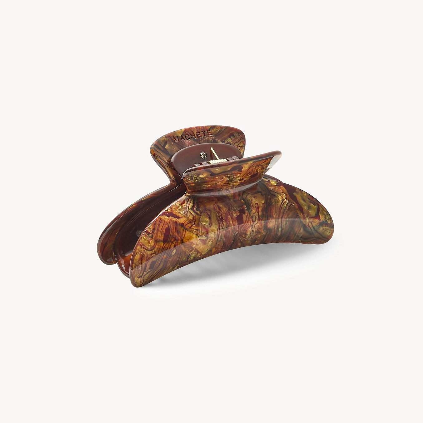 Brown tortoiseshell hair clip on a white background