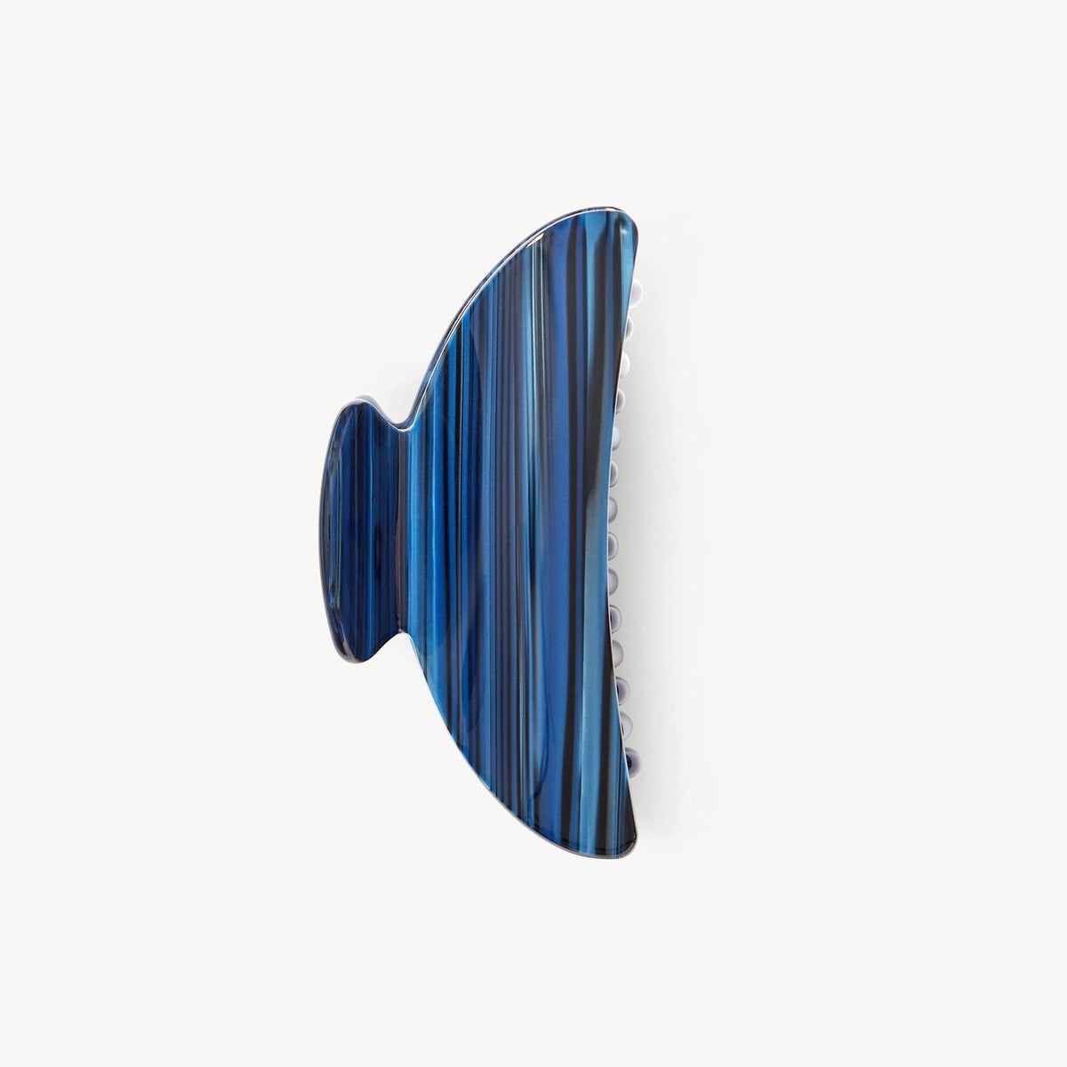 A single hair claw clip in a glossy blue and black striped pattern, shown against a plain off-white background.