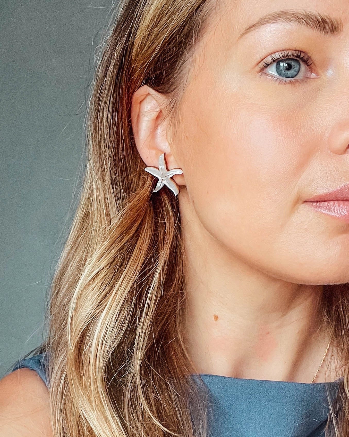 Pepper You Acrylic & Wood Starfish Stud Earrings being worn by a model with blond hair and a blue top
