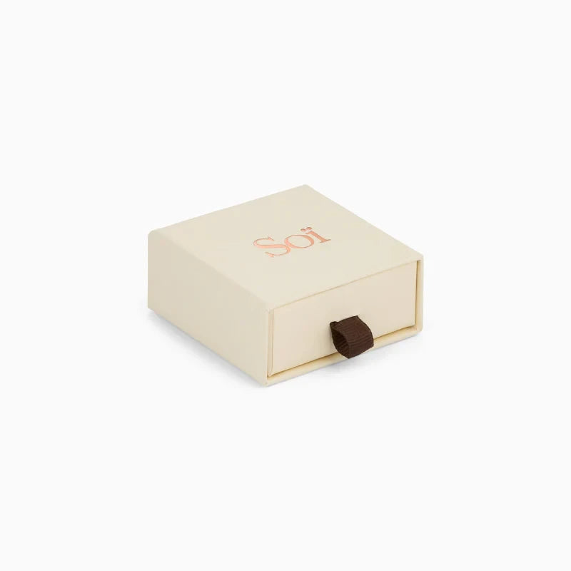 Soï Copenhagen Ava huggie hoop earrings in 18k gold with a faceted crystal stone jewellery box