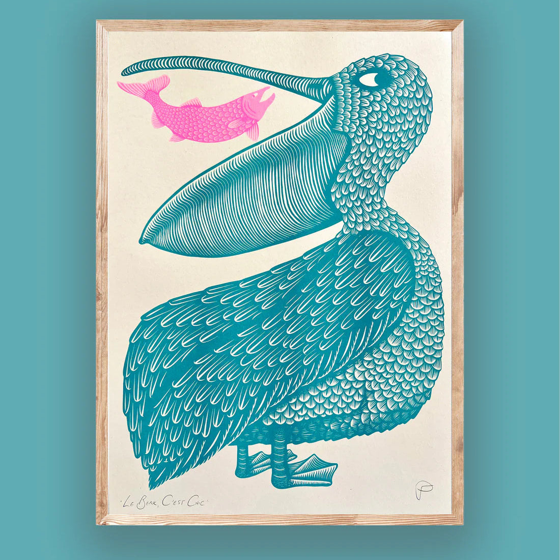 Framed artwork of a blue pelican and pink fish on a beige background