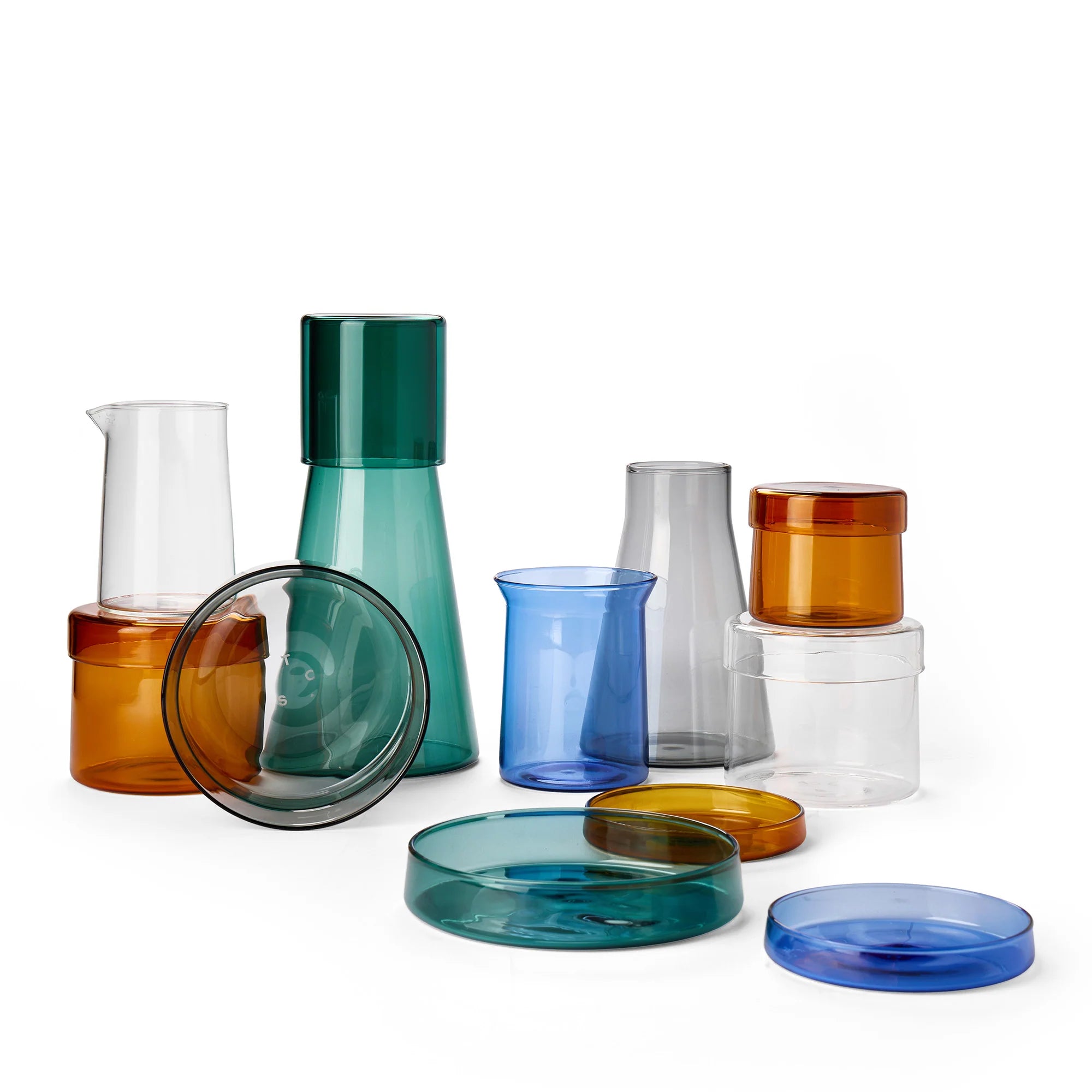 Set of colorful glass kitchenware items on a white background