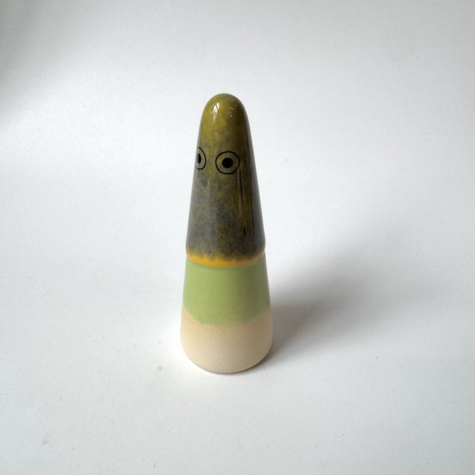 Kylie Studio Arhoj ghost olive-green top, a grey-brown middle section, a pale green band, and a cream-coloured base, standing on a plain light background.