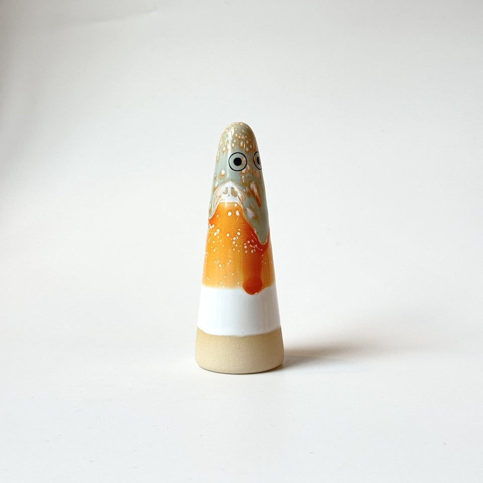 Bee Stuido Arhoj ghost, featuring a hand-painted face and body in orange, white, and beige glazes, set against a plain white studio background.