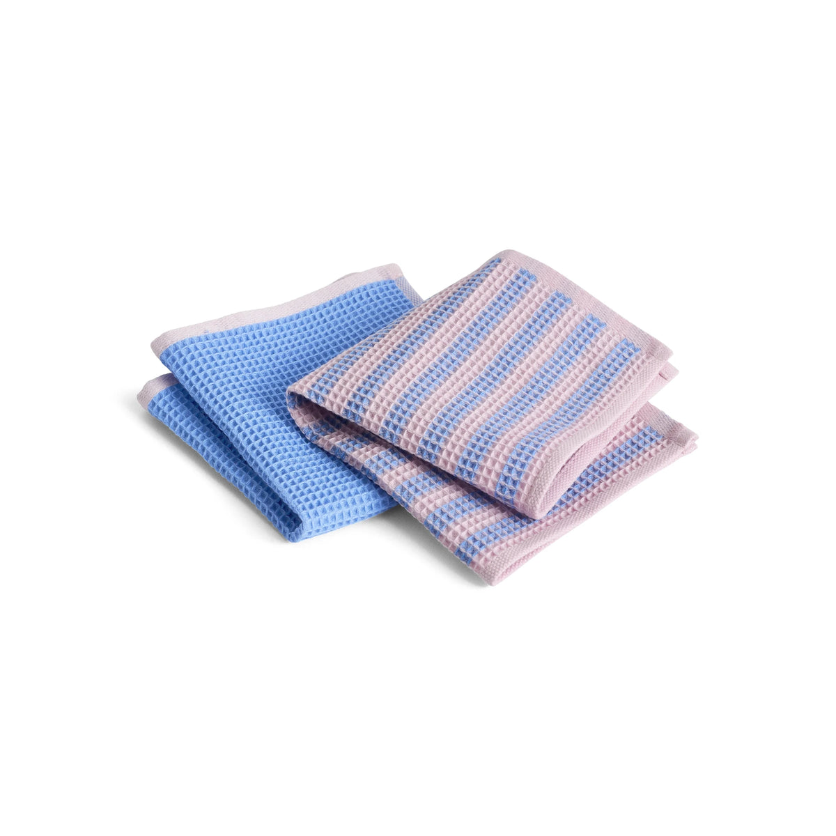 Two folded textured HAY Canteen cloth towels stacked on a white background, one solid light blue and one striped in light blue and pale pink.