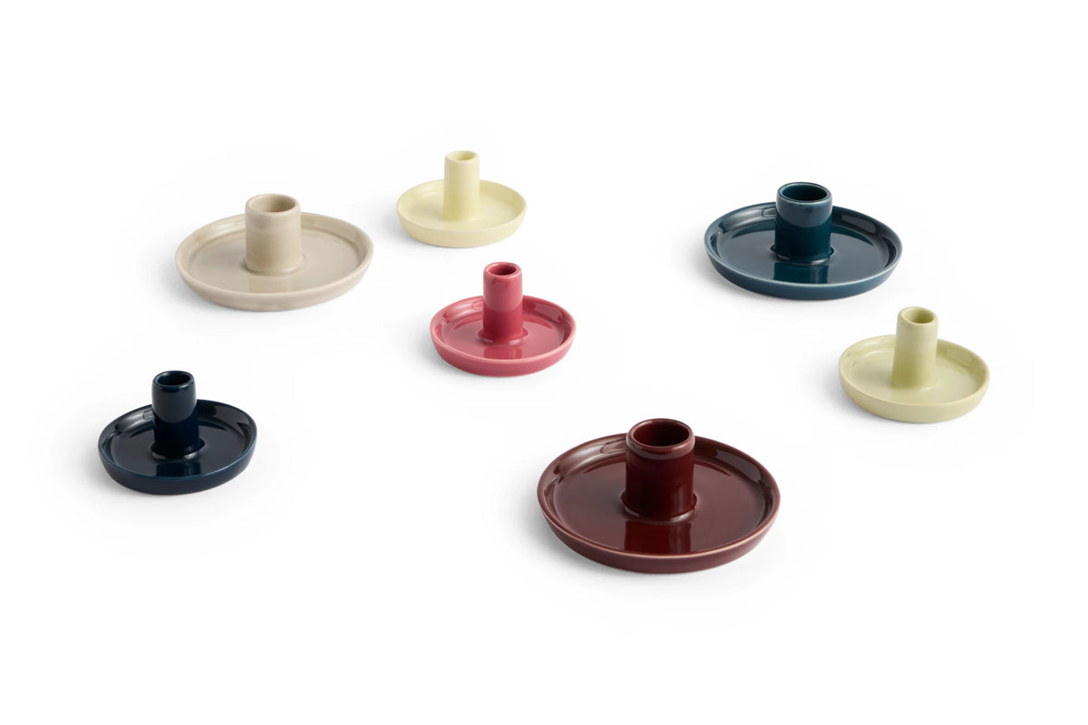 Set of colorful HAY ceramic disc candle holders on a white background