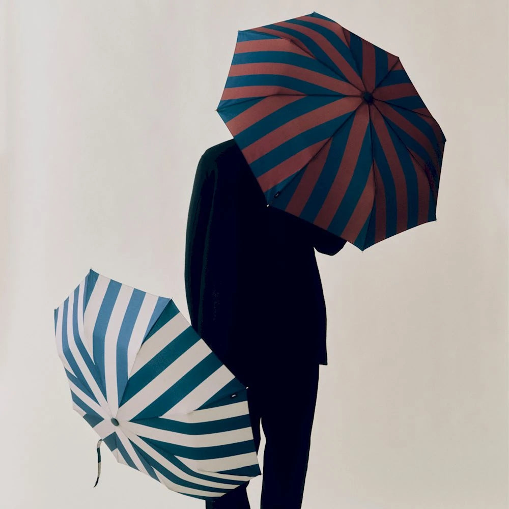 HAY Regn umbrella held by a model open on a white background