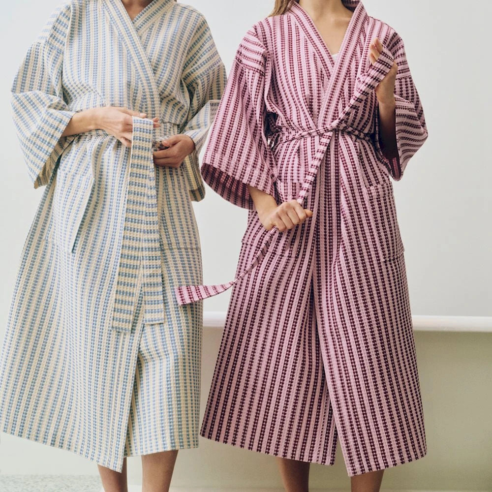 Two models wearing the HAY striped waffle bathrobes.