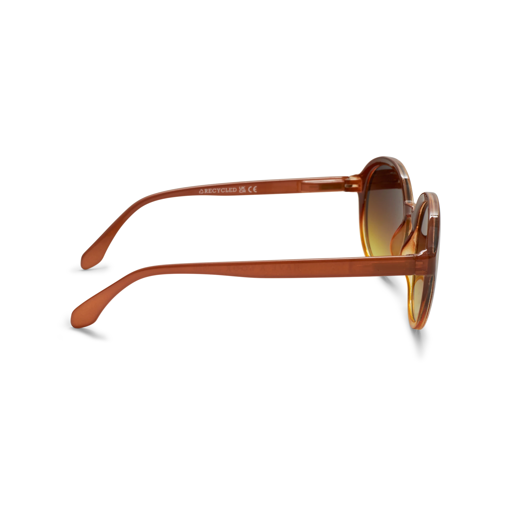 Round sunglasses with translucent amber-brown frames and gradient brown lenses, shown from a side profile on a white background.