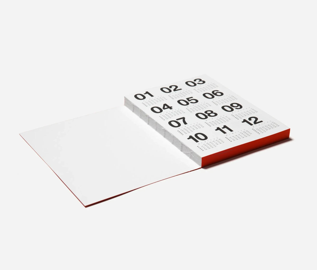 A minimalist Marjolein Delhaas planner displaying a calendar, shown on a light grey background.