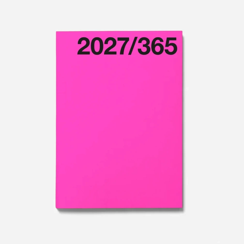 A bright pink Marjolein Delhaas planner cover with the black text '2027/365' printed at the top, shown on a light grey background.