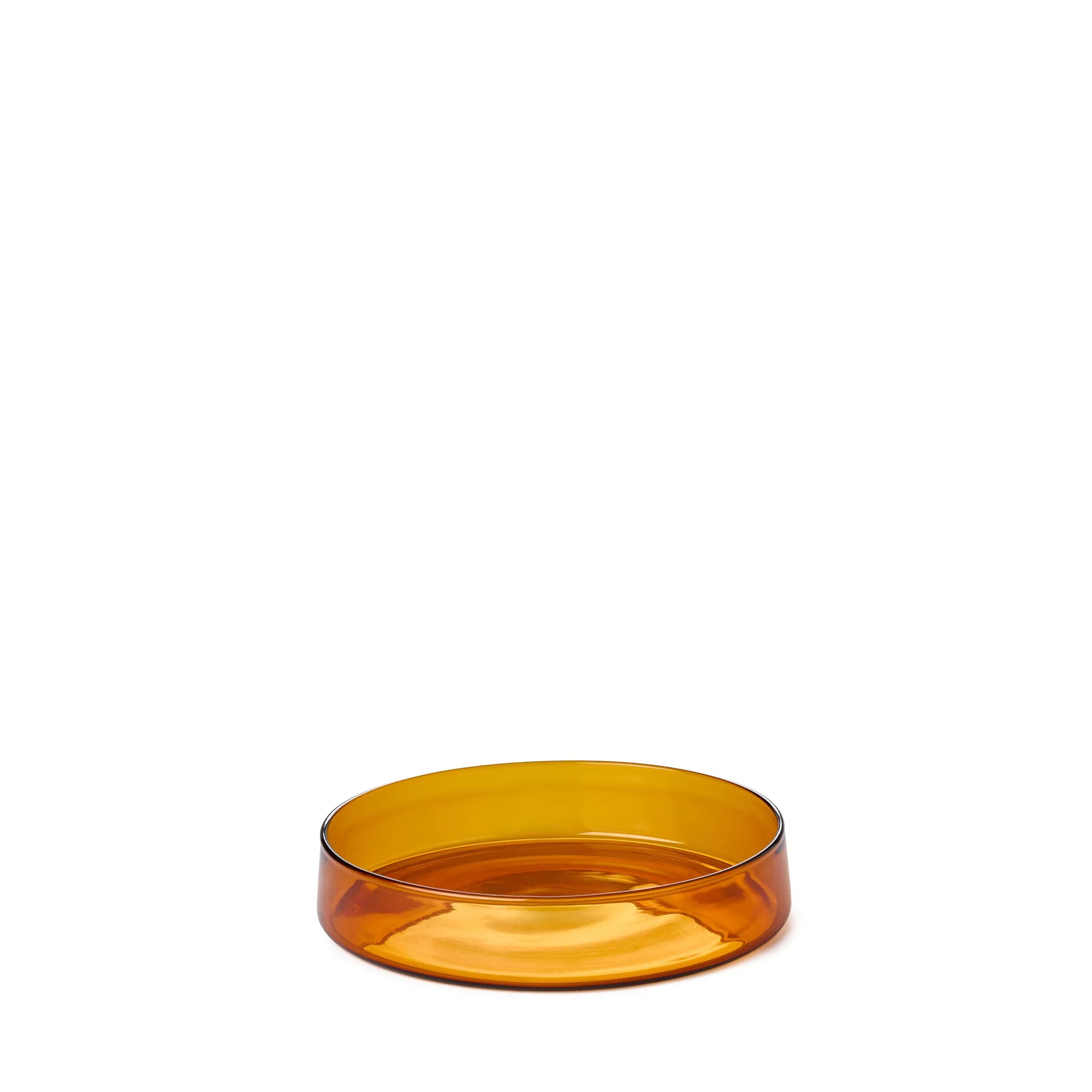 Transparent amber glass bowl on a white background