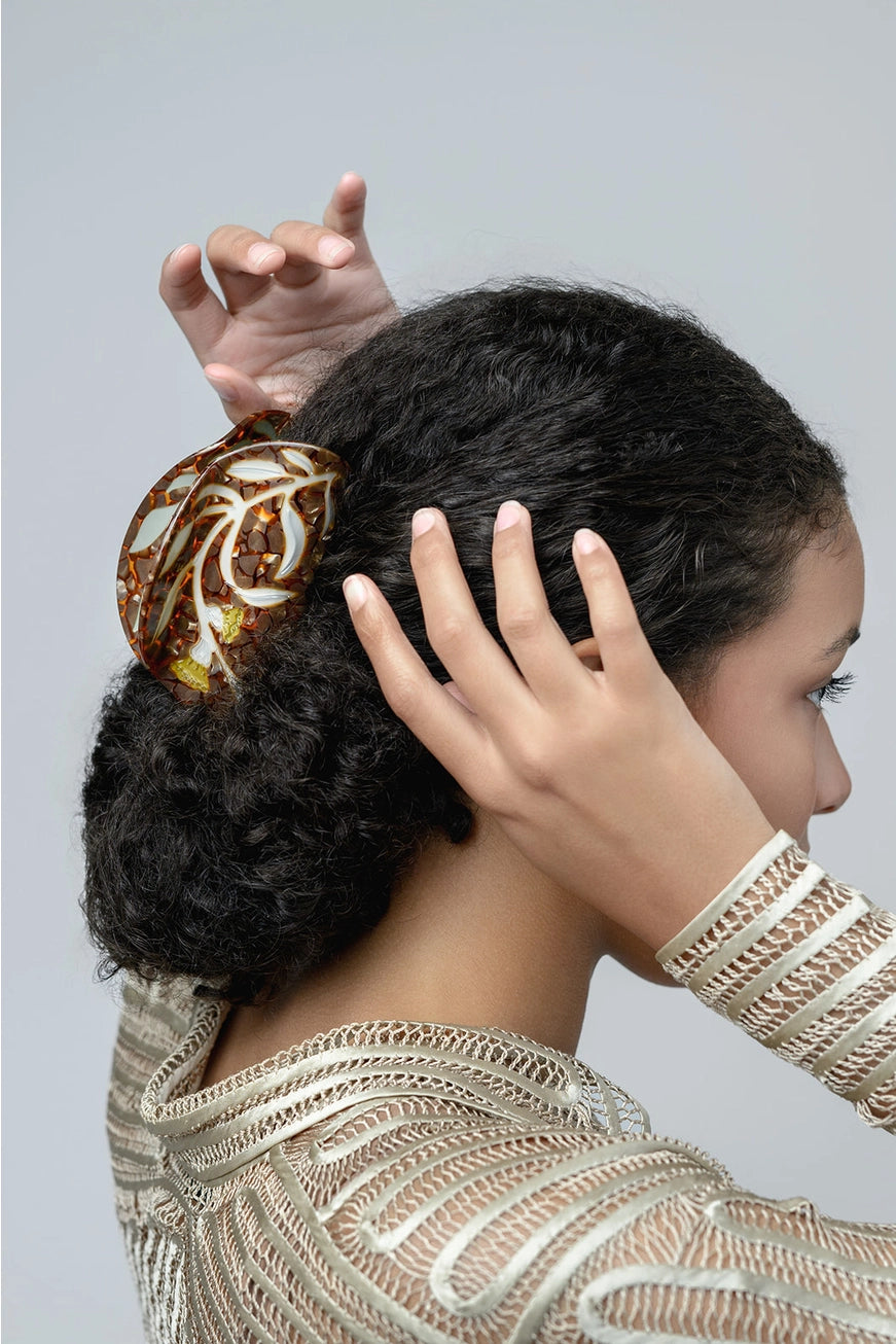 Winona Irene Artemesia XL Deep Hair Claw being demonstrated by a female model with thick textured hair in a low bun