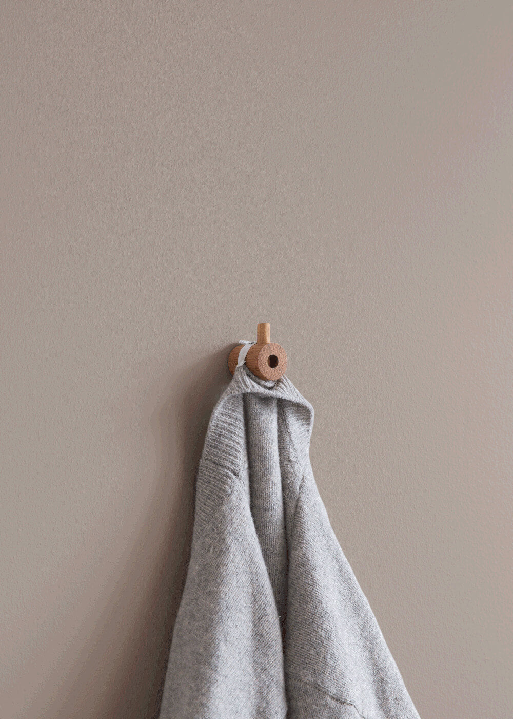 Moebe Wooden Wall Hook in Natural Oak in use with a towel