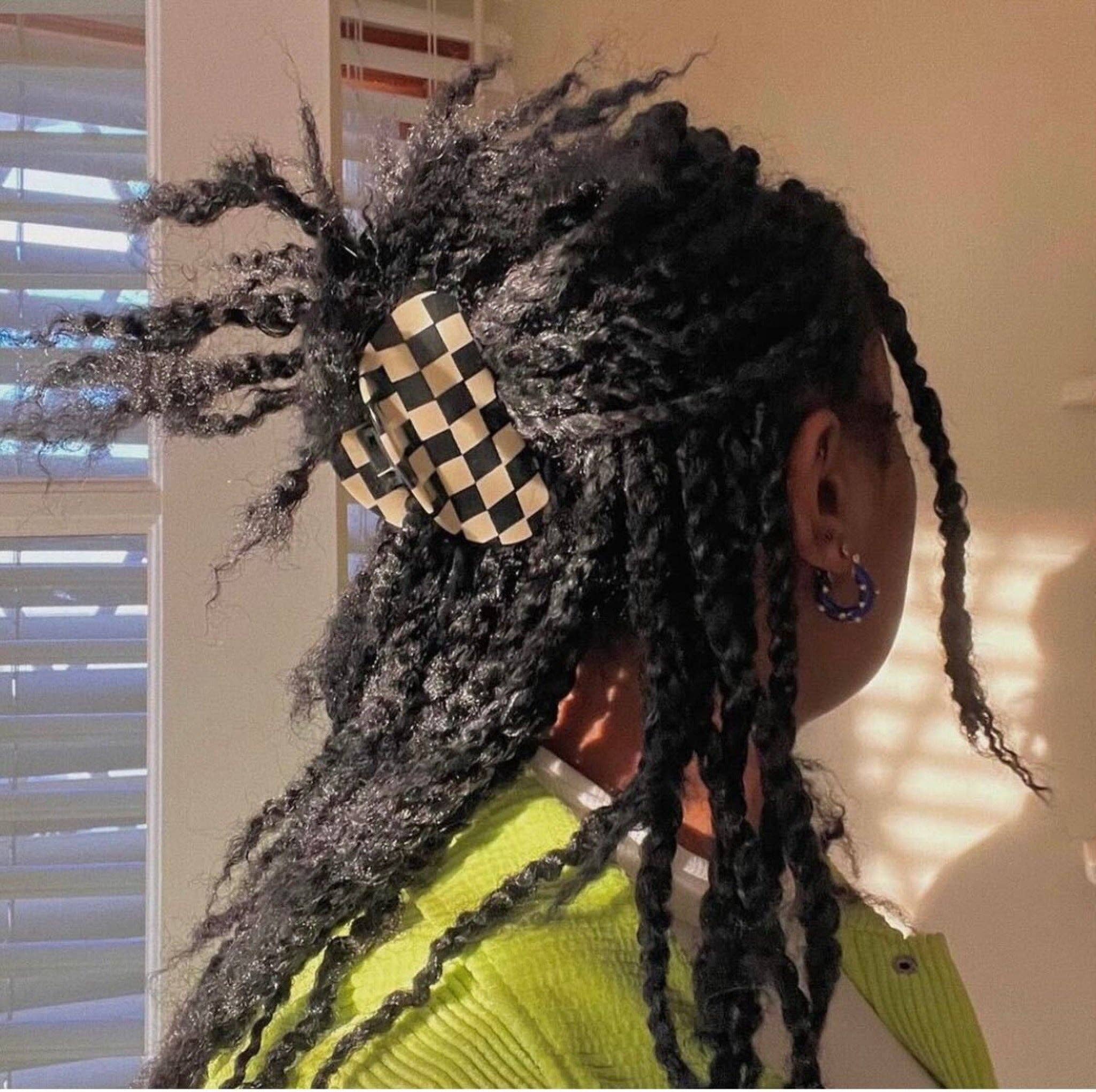 CHUNKS Checker Hair Claw in black and white being worn by a model with black textured hair in a half up do