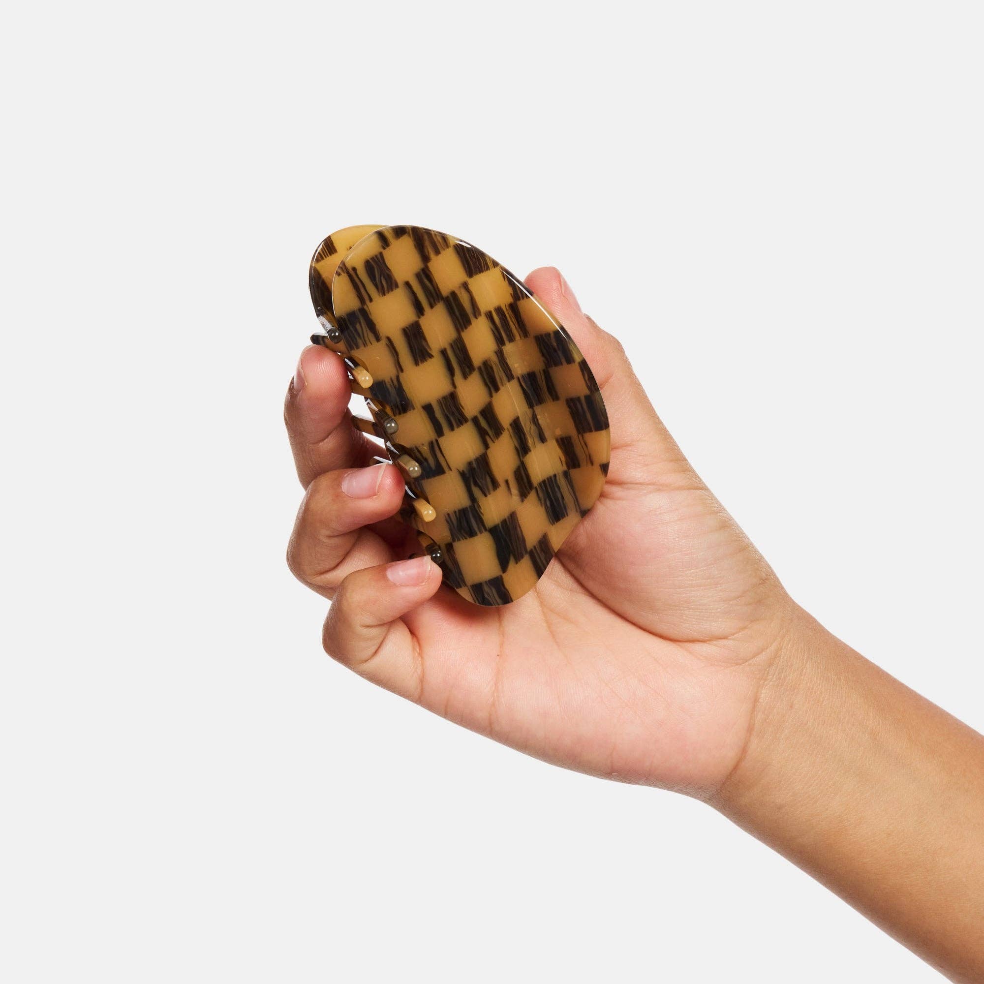 CHUNKS Checker Hair Claw in Mocha being held by a models hand