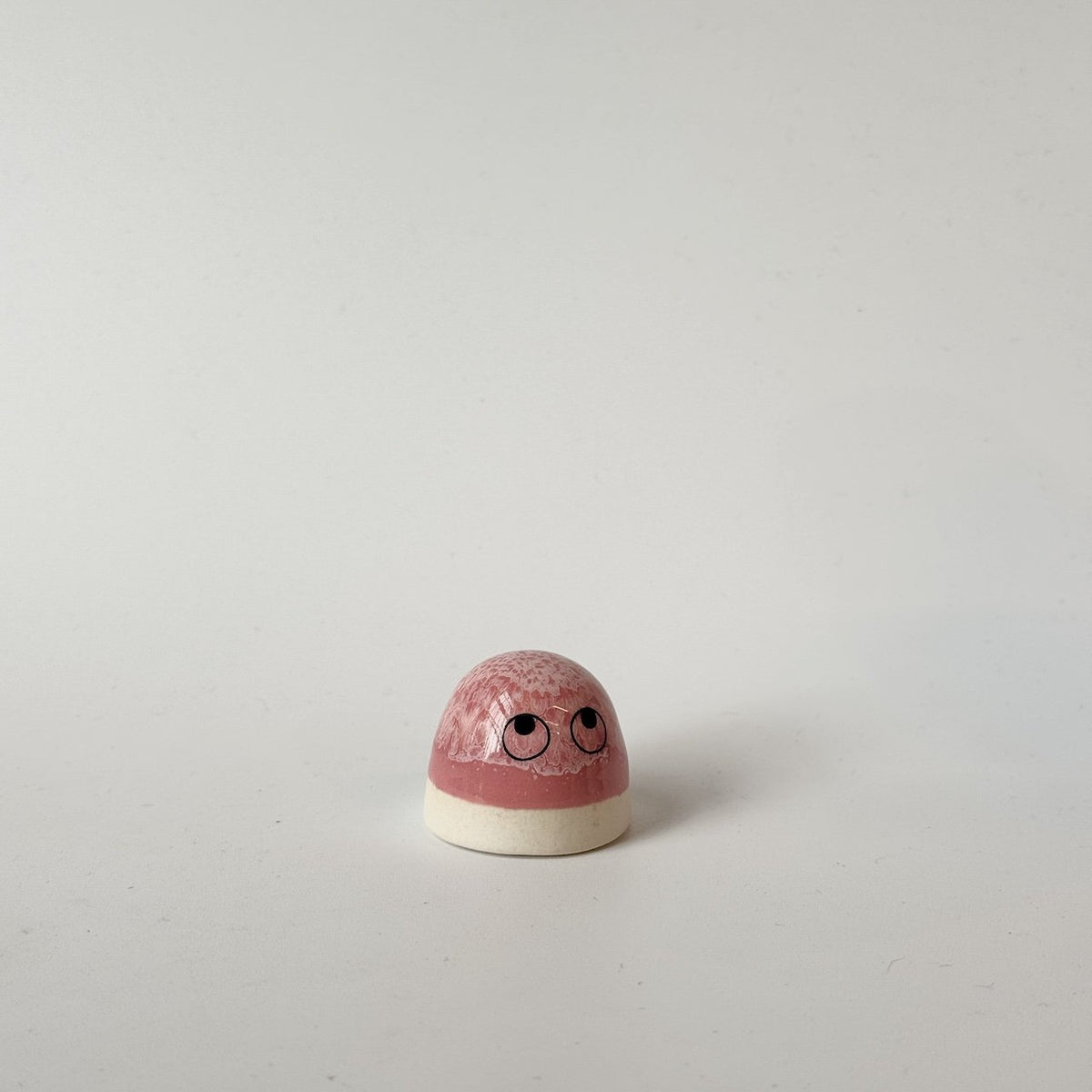 Luca, a pink Studio Arhoj 'Dot' set against a plain light gray background.